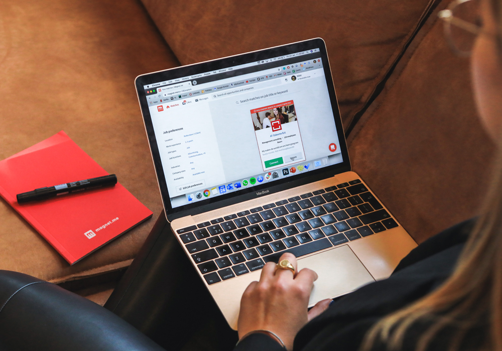 student using a laptop on a couch