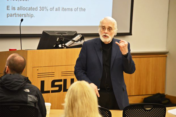 Speaker at seminar at the front of the classroom