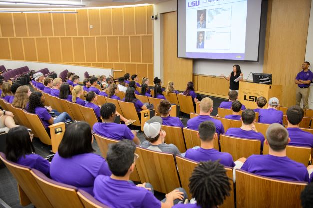 BRC residents in purple shirts in lecture hall