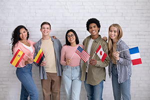 Photo of young people holding flags from different countries.