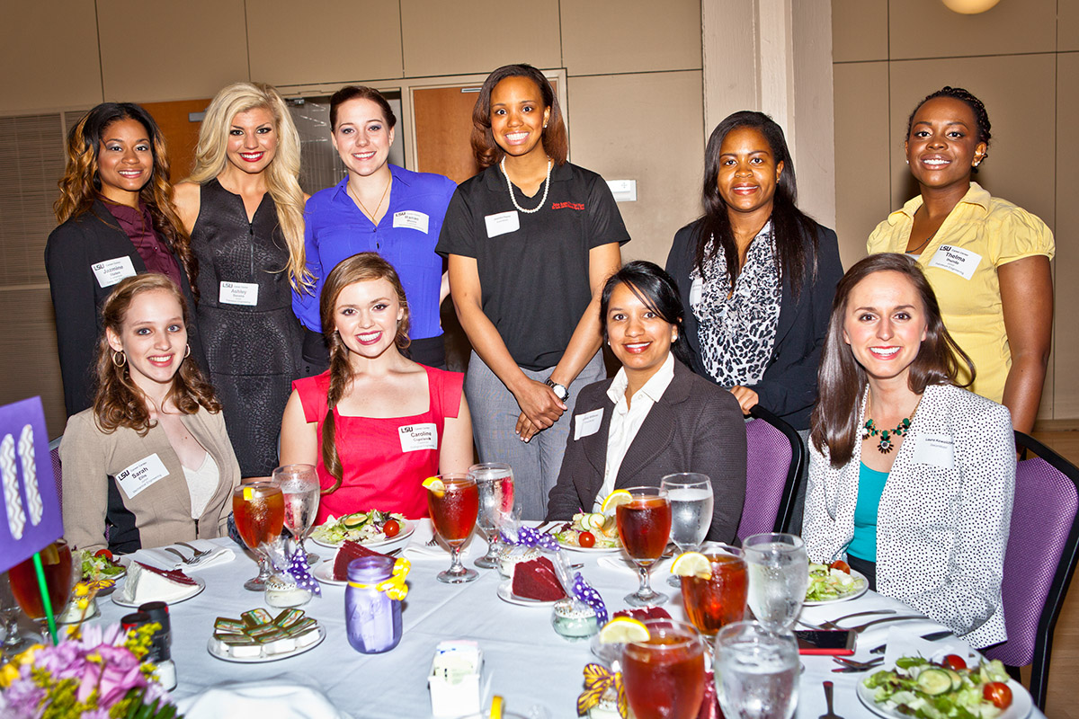 Group photo of several women at a formal dinner